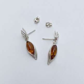 Silver earring with amber.